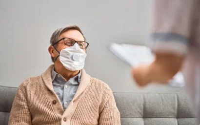 Senior man wearing a face mask in his retirement home