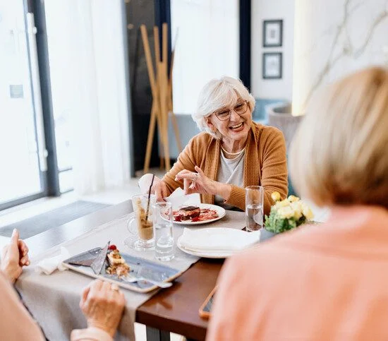 Senior women talking while having dessert