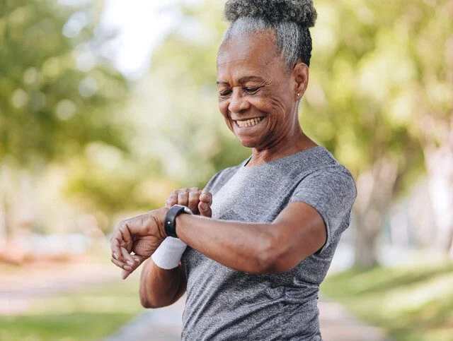Senior woman checking the time on smartwatch