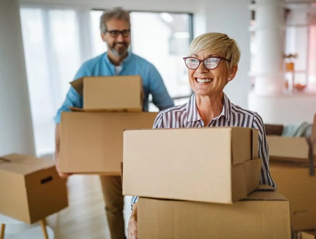 Portrait of happy smiling senior couple in love moving in new home