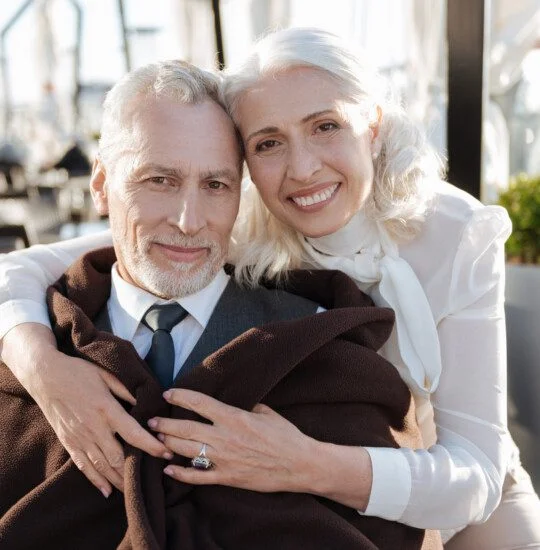 Happy couple of lovers looking straight at camera