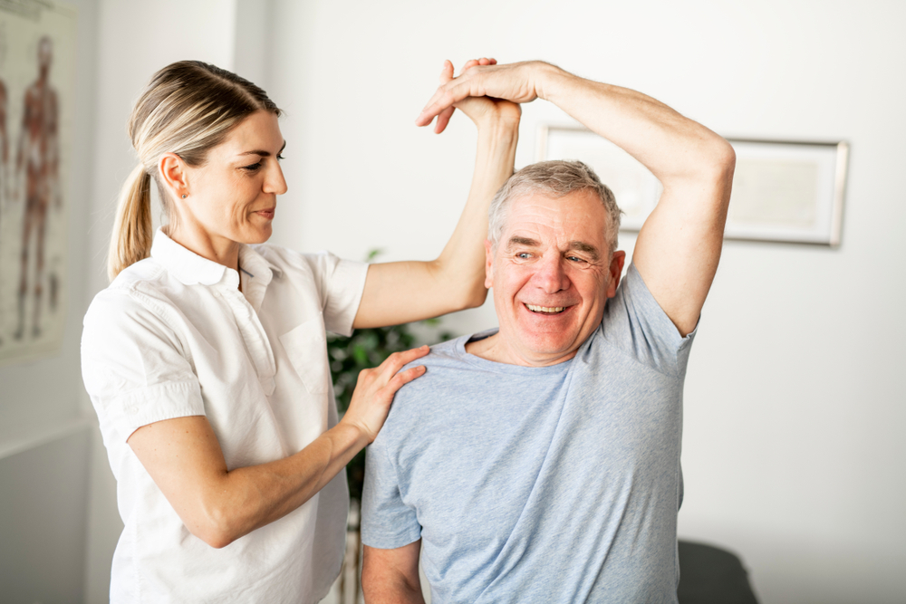 Senior man doing physical therapy exercises