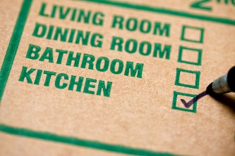 close-up of label section of packing box, with marker checking "kitchen" to show where the contents of the box belong
