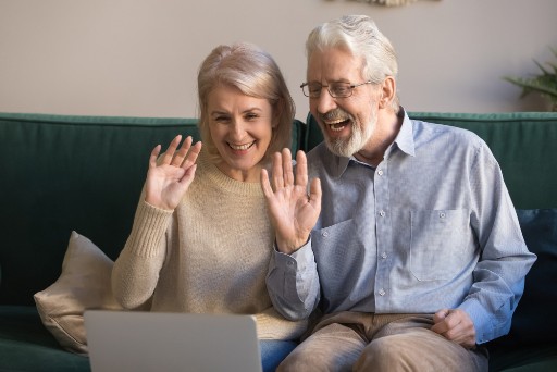 senior couple chatting with loved ones over a video call to avoid isolation