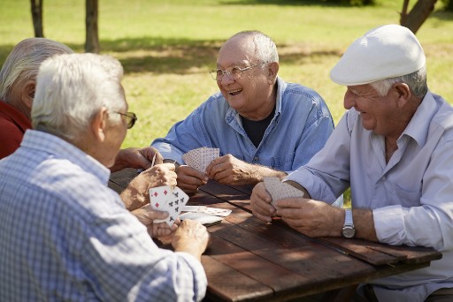 senior men playing cards in their retirement community