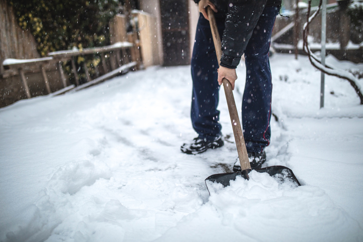 close-up of senior man shoveling snow