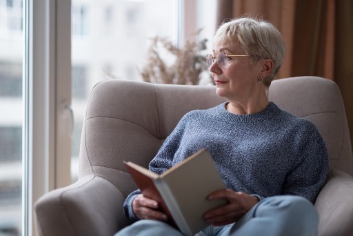 isolated senior woman reading a book to avoid isolation