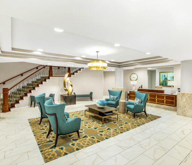 expansive lobby with seating and modern decor at Claridge Court Senior Living Community