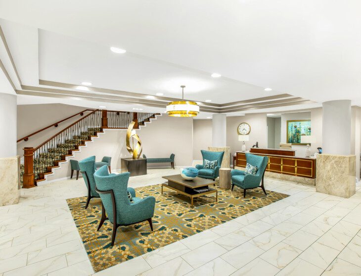 expansive lobby with seating and modern decor at Claridge Court Senior Living Community