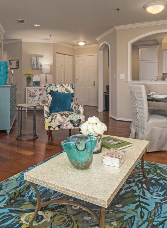 spacious living room and dining area of senior apartment at Claridge Court Senior Living Community