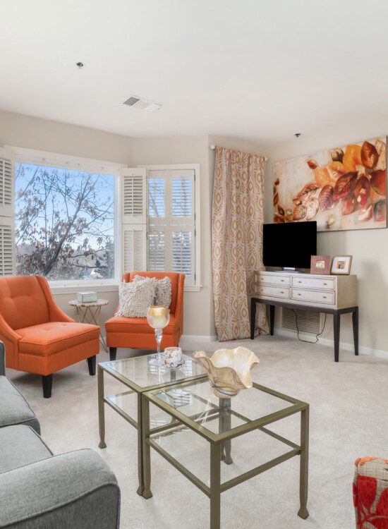 spacious living room and dining area of senior apartment at Claridge Court Senior Living Community