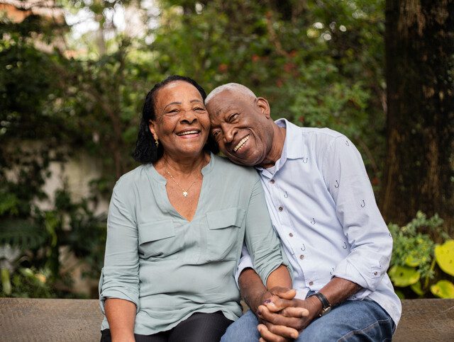 Senior couple sitting together outdoors