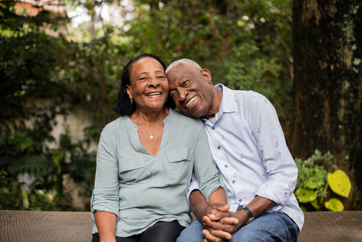 Senior couple sitting together outdoors