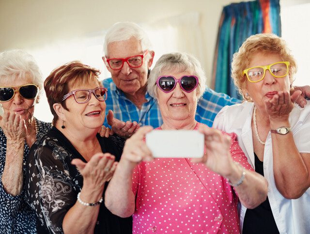 A group of seniors having fun and taking pictures together