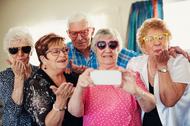 A group of seniors having fun and taking pictures together